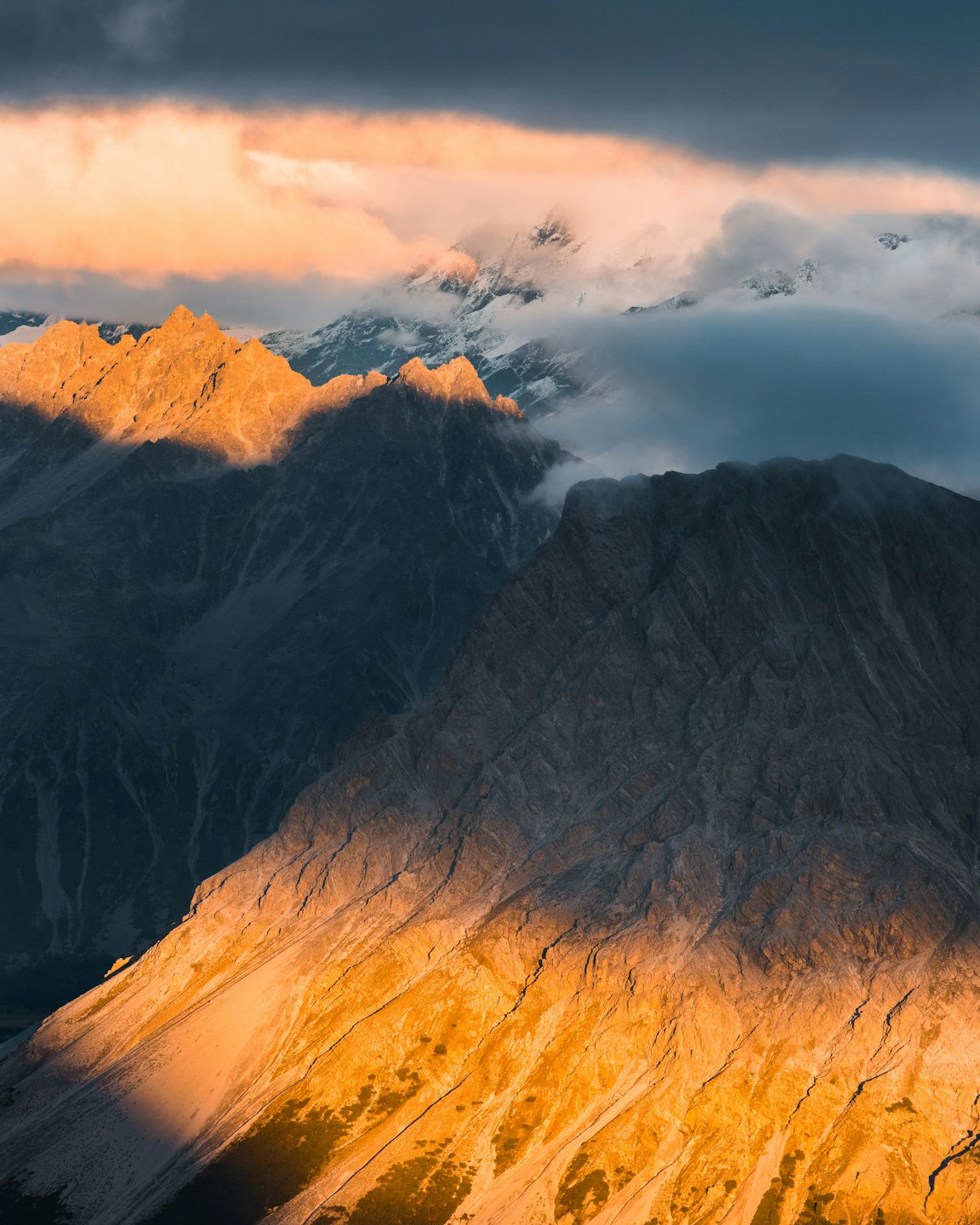 Jagged mountain peaks bathed in warm sunrise light.